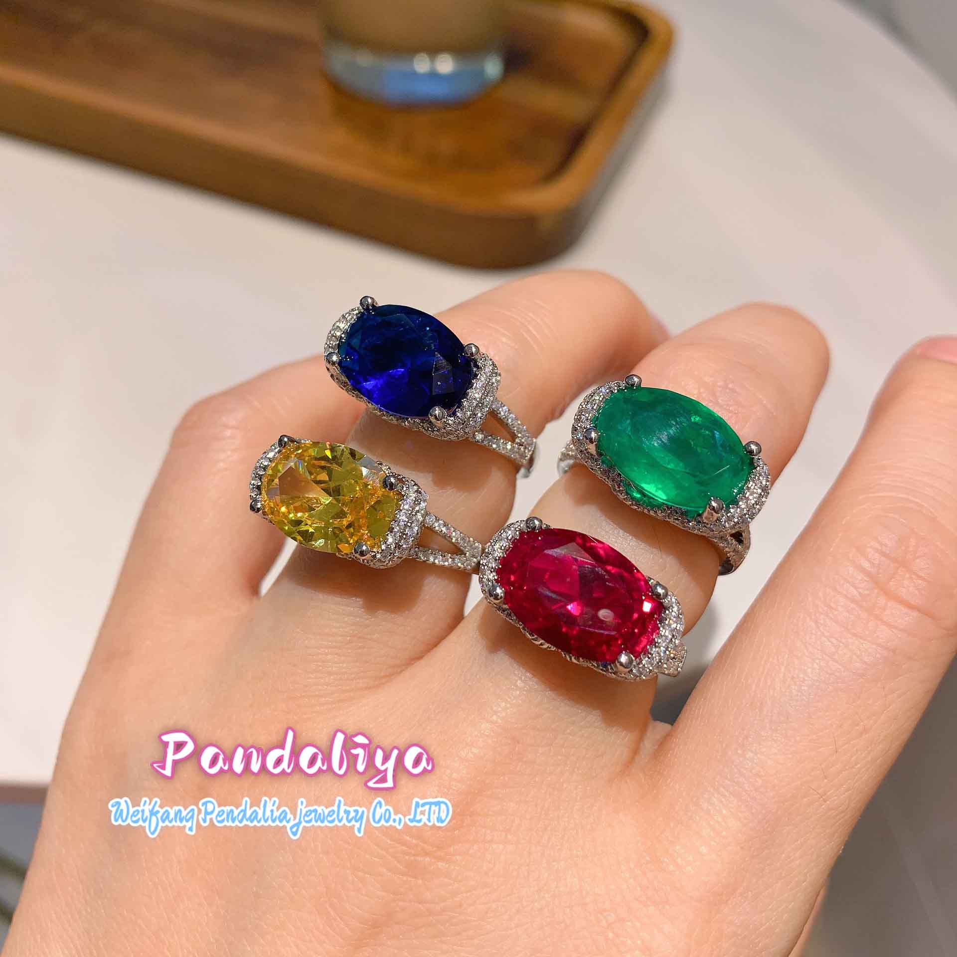 Four different-colored gemstone rings, sparkling with diamond accents, shine brilliantly, showcasing the luxuriousness of diamonds and the colorful charm, attracting all eyes.