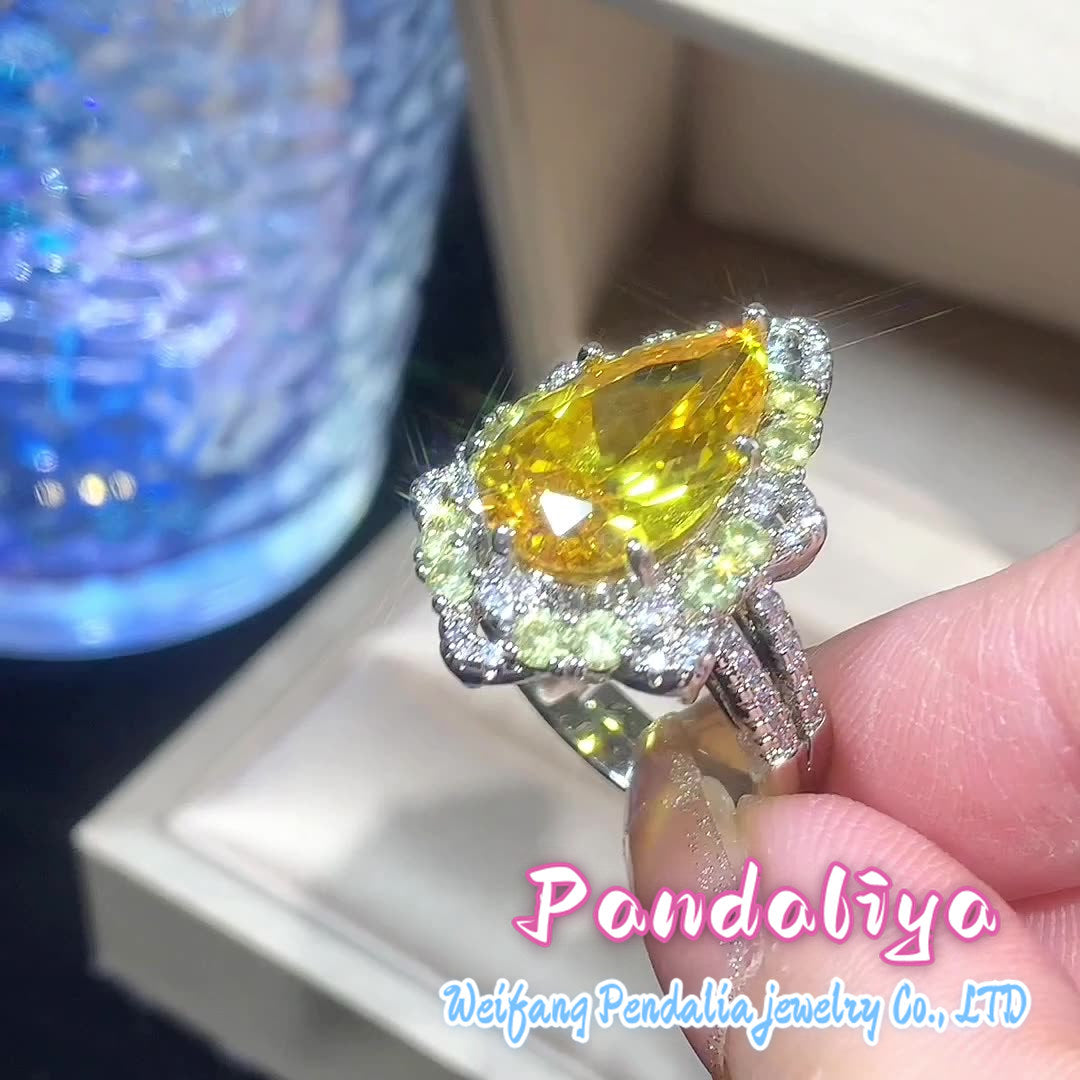 Colorful gemstone ring with water drop design, adorned with sparkling diamonds, radiating charming brilliance, truly eye-catching!