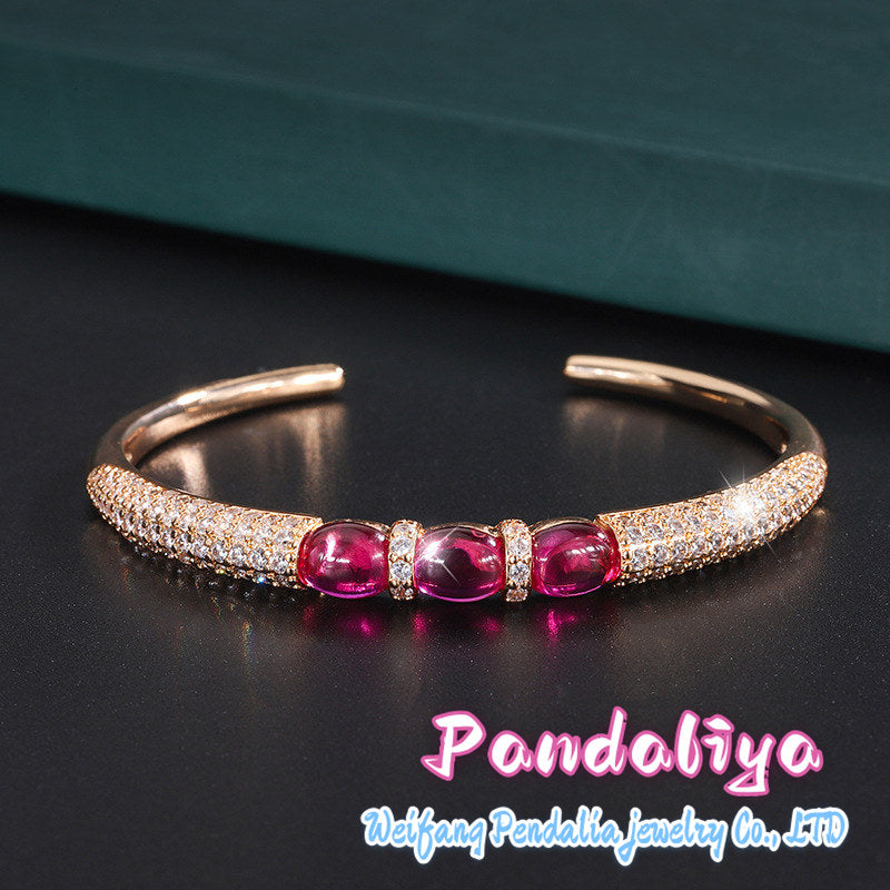 Ruby bracelet, featuring a simple smooth cut design and adorned with dazzling diamonds, showcases unparalleled charm with its passionate and vibrant red hue, making you shine like a star under the spotlight!