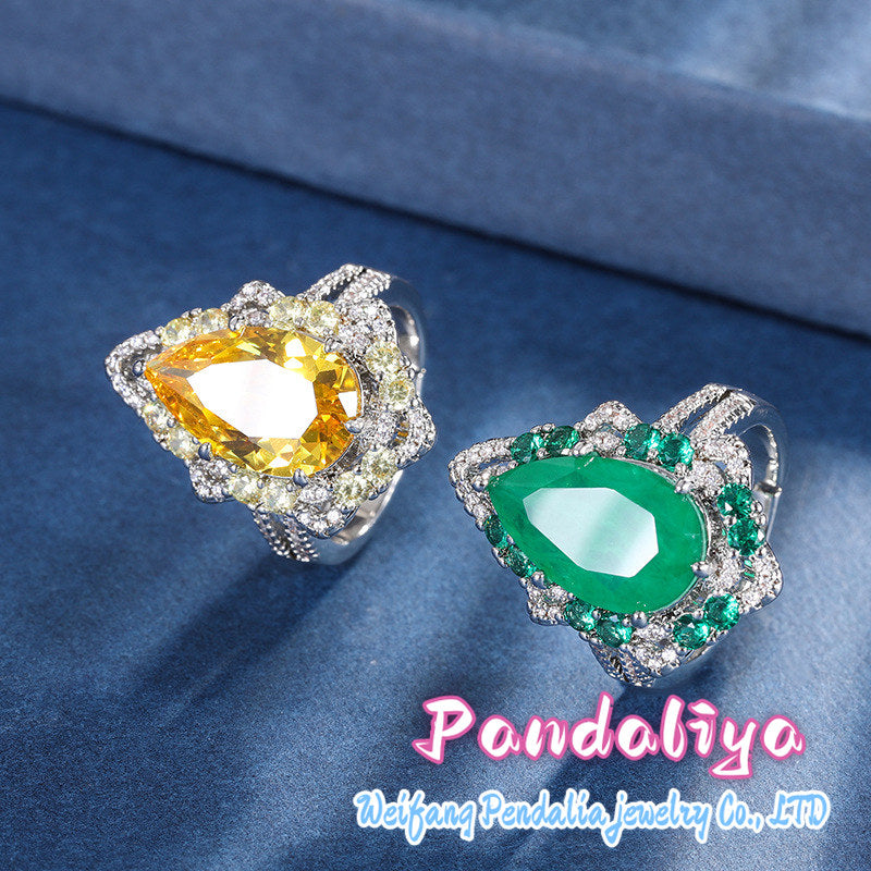 Colorful gemstone ring with water drop design, adorned with sparkling diamonds, radiating charming brilliance, truly eye-catching!