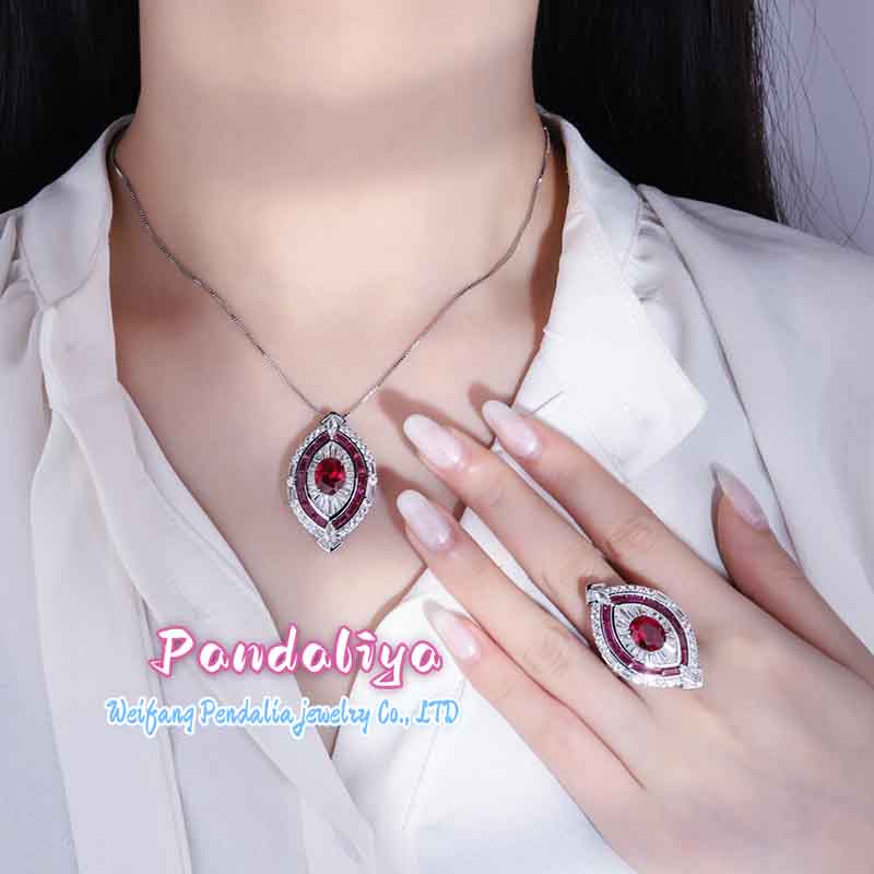 Red ruby set, exquisitely designed, shimmering with full-set diamonds, radiating a magnificent and dazzling brilliance, showcasing luxurious taste.