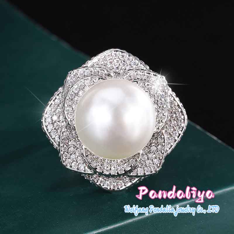 The classic 14mm pearl camellia design ring, with unique craftsmanship and exquisite style, ensures quality and perfectly showcases your fashion taste.