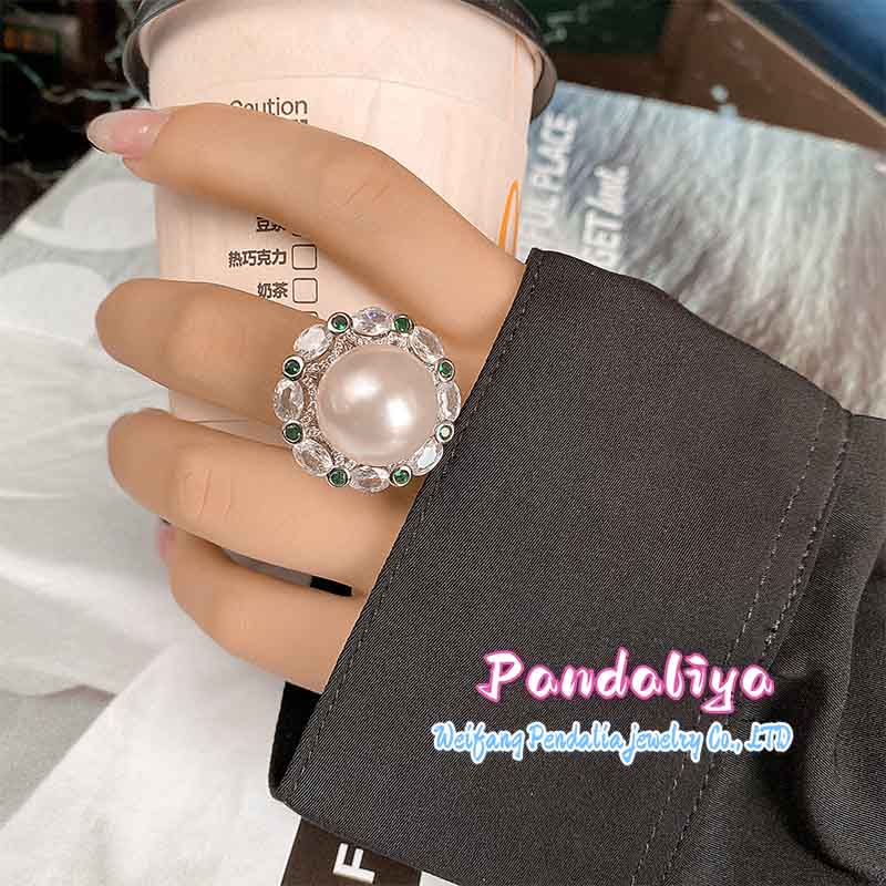 A magnificent ring adorned with large pearls and colorful gemstones, complementing each other perfectly, vibrant and charming, enhancing your unique charm.