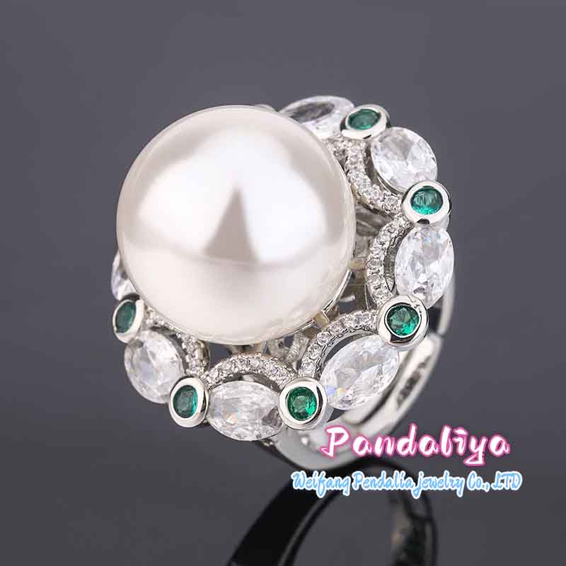 A magnificent ring adorned with large pearls and colorful gemstones, complementing each other perfectly, vibrant and charming, enhancing your unique charm.