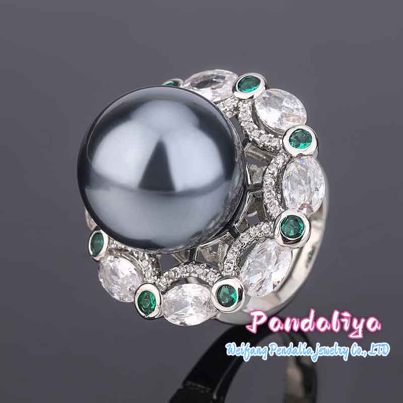 A magnificent ring adorned with large pearls and colorful gemstones, complementing each other perfectly, vibrant and charming, enhancing your unique charm.