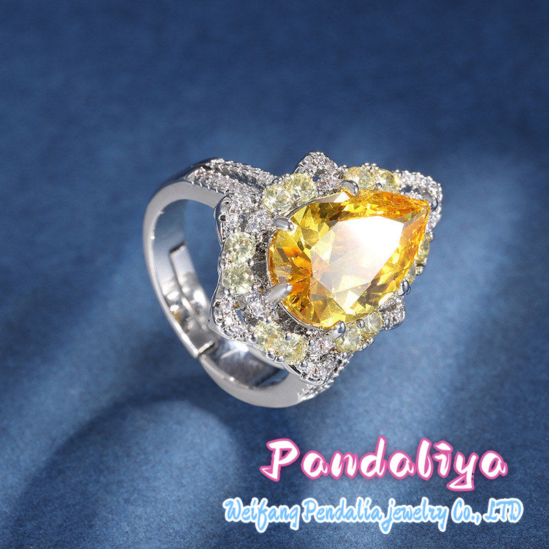 Colorful gemstone ring with water drop design, adorned with sparkling diamonds, radiating charming brilliance, truly eye-catching!