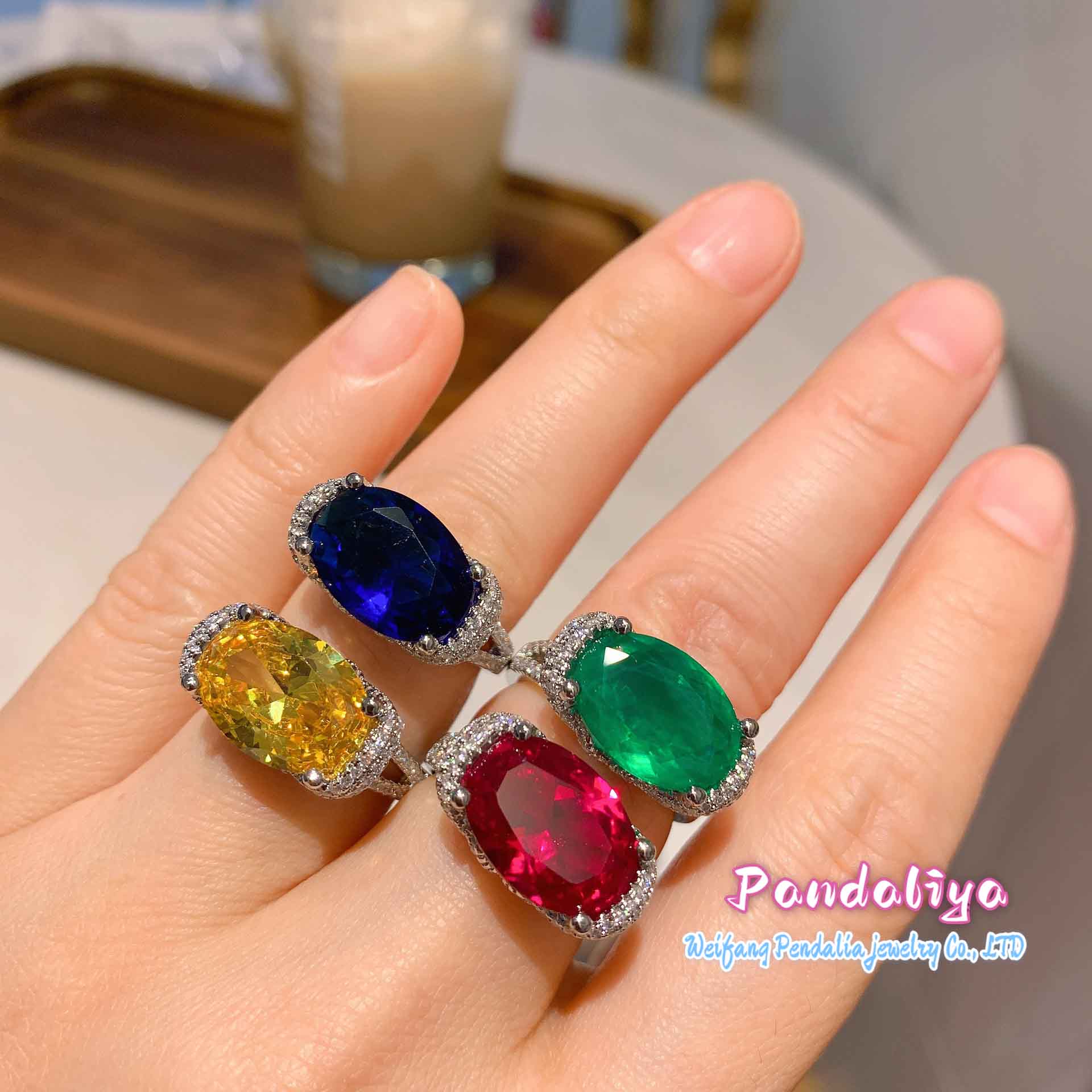 Four different-colored gemstone rings, sparkling with diamond accents, shine brilliantly, showcasing the luxuriousness of diamonds and the colorful charm, attracting all eyes.