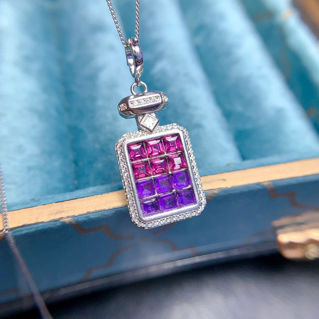 A pendant made of natural gemstones, designed to open, available in four different color options.