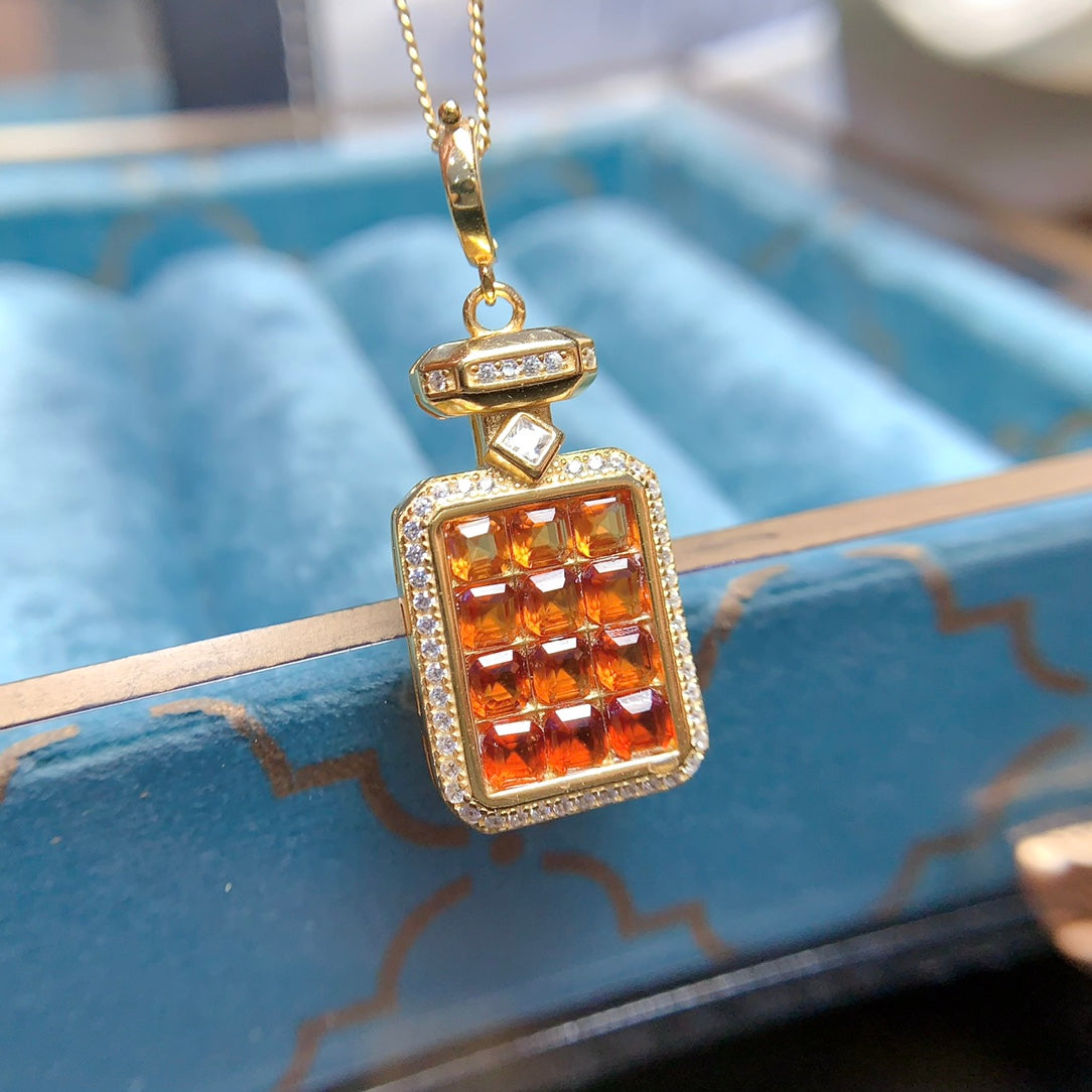 A pendant made of natural gemstones, designed to open, available in four different color options.