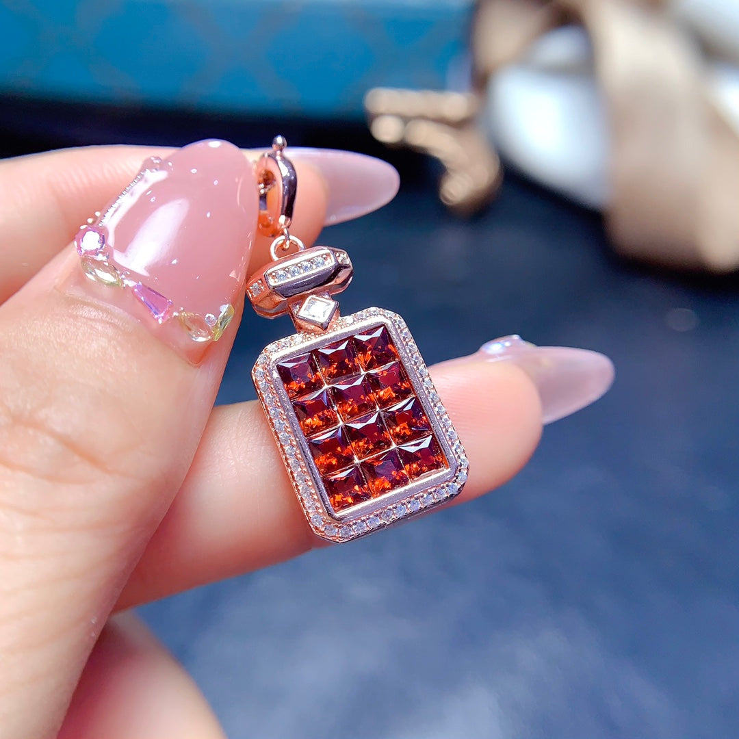 A pendant made of natural gemstones, designed to open, available in four different color options.