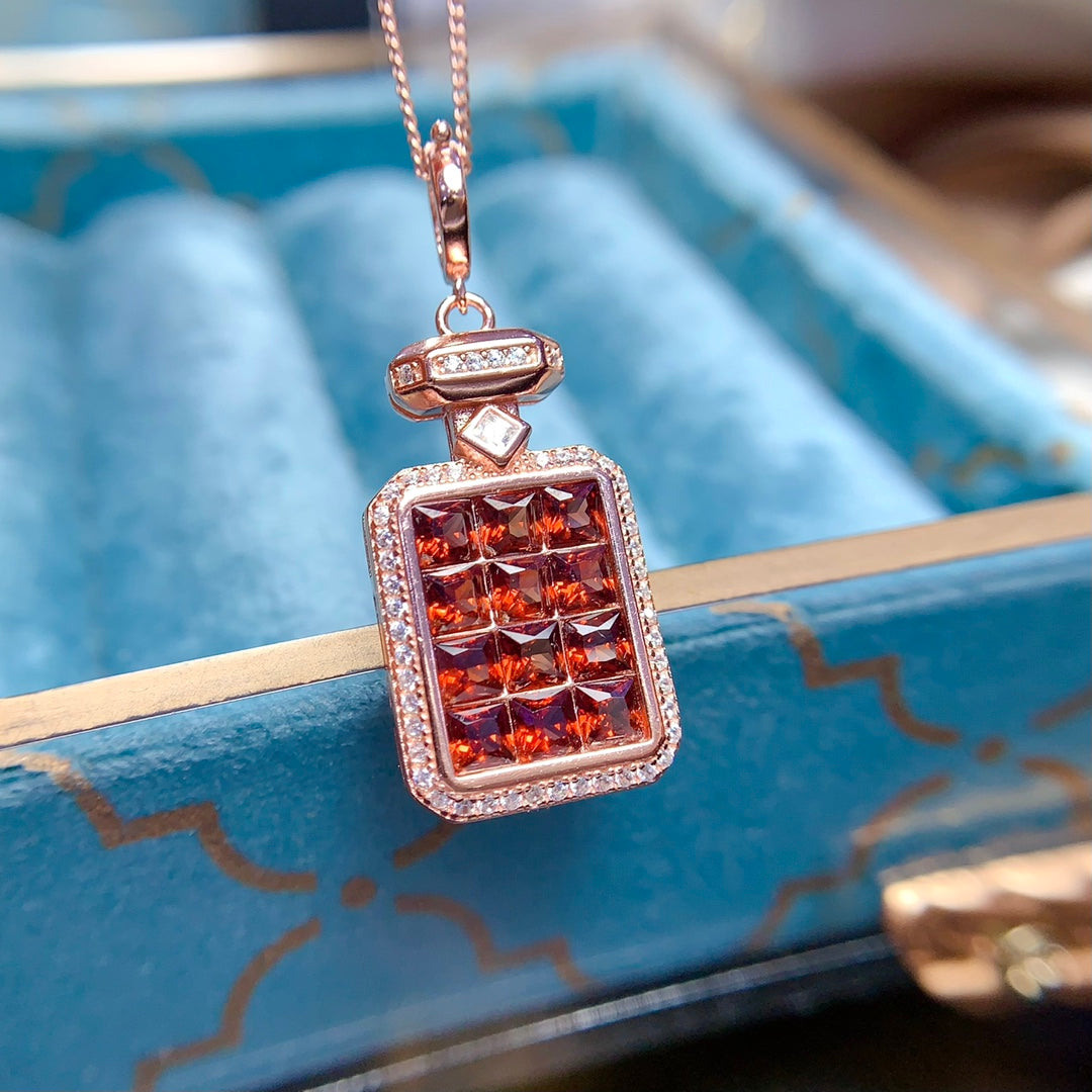 A pendant made of natural gemstones, designed to open, available in four different color options.