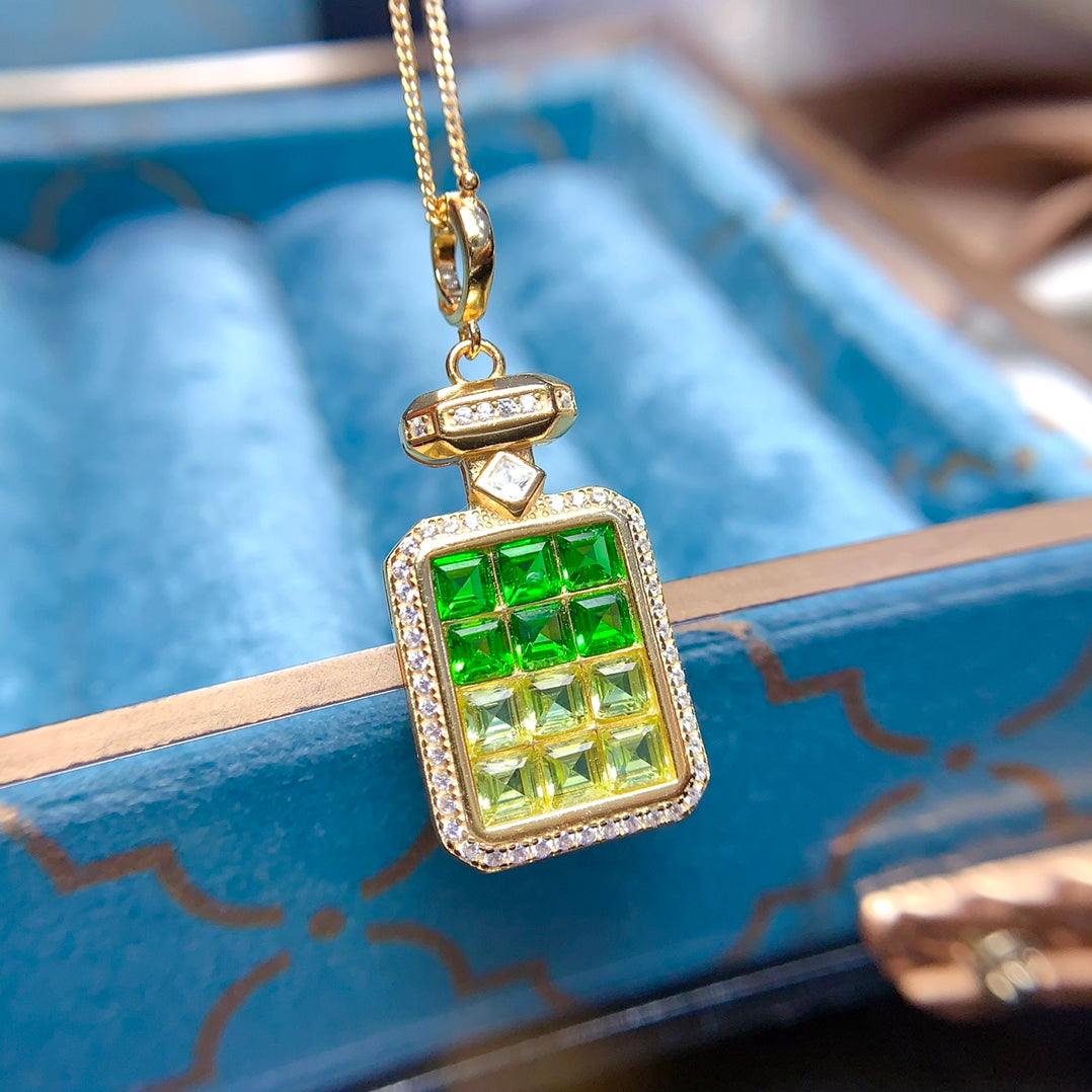 A pendant made of natural gemstones, designed to open, available in four different color options.