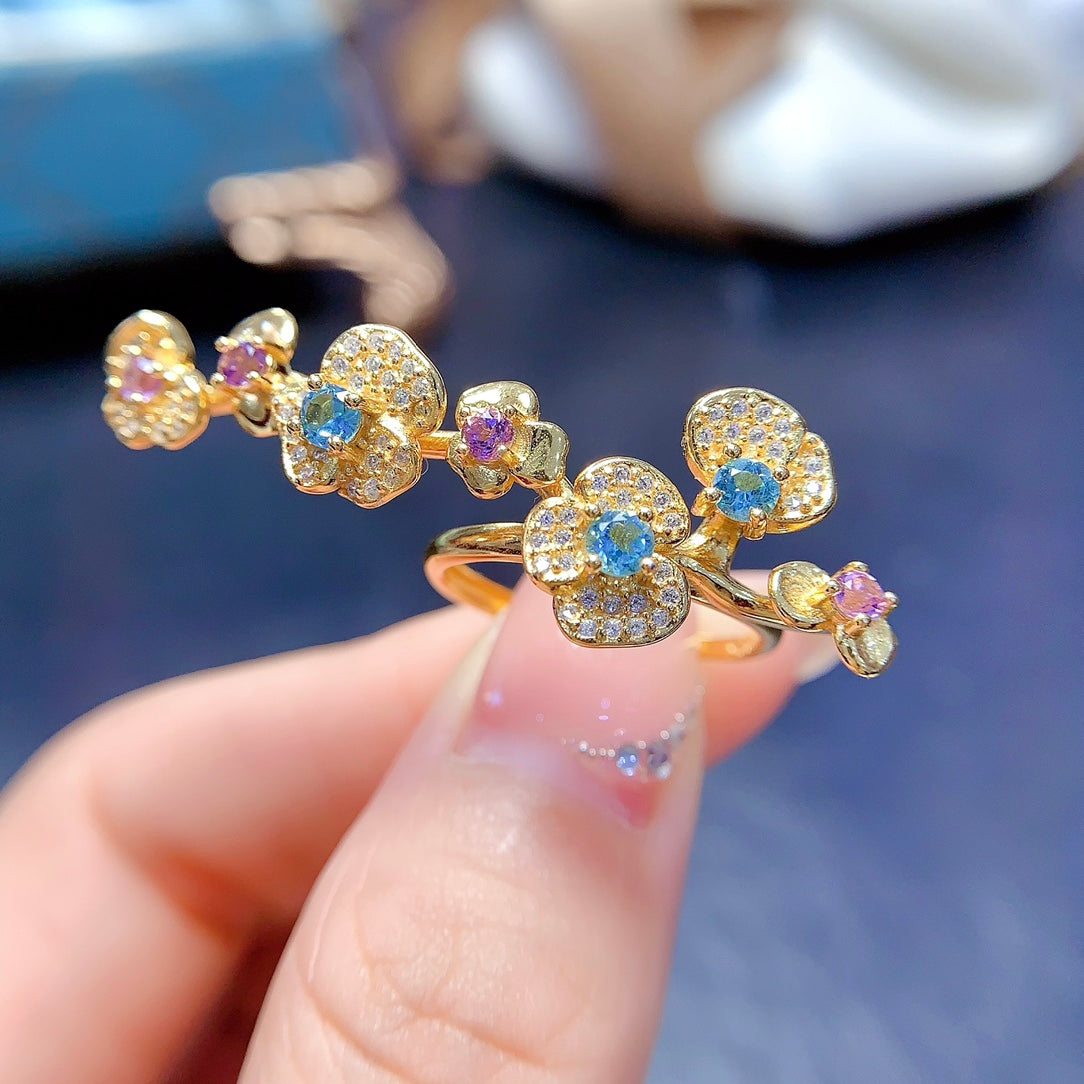 A ring crafted from natural crystal and topaz, this piece exudes a unique, floral-inspired design that resembles a delicate flower blooming on your hand.