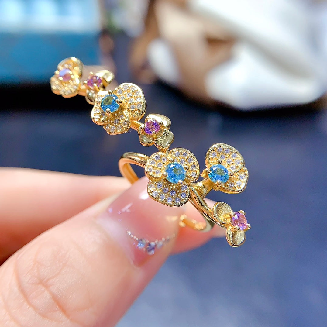 A ring crafted from natural crystal and topaz, this piece exudes a unique, floral-inspired design that resembles a delicate flower blooming on your hand.