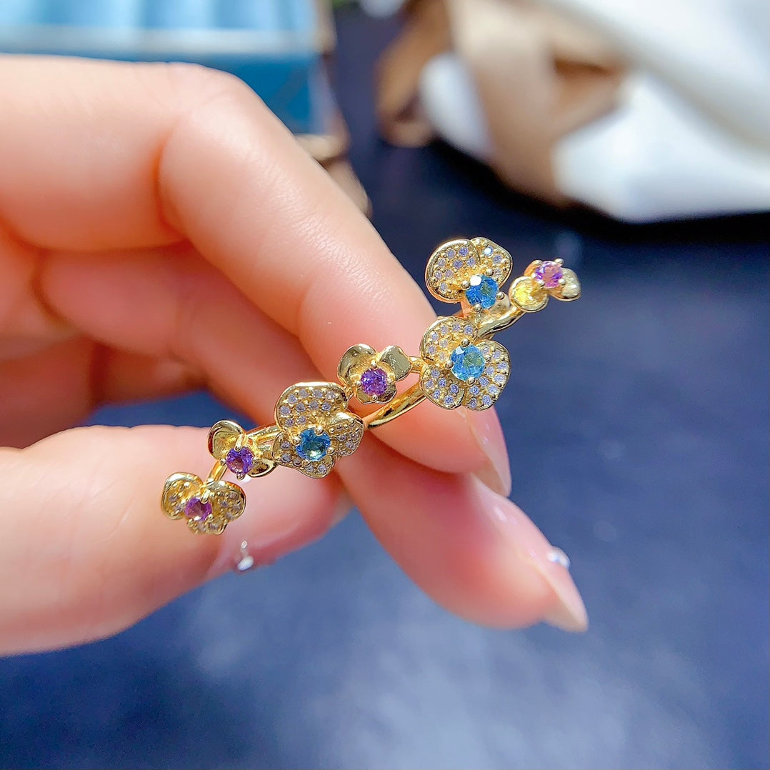 A ring crafted from natural crystal and topaz, this piece exudes a unique, floral-inspired design that resembles a delicate flower blooming on your hand.