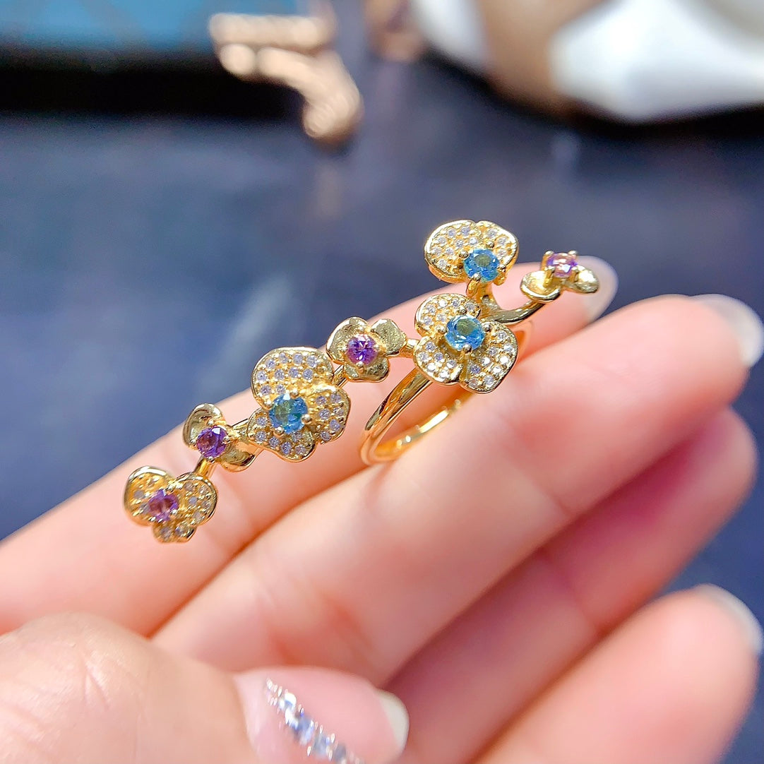 A ring crafted from natural crystal and topaz, this piece exudes a unique, floral-inspired design that resembles a delicate flower blooming on your hand.