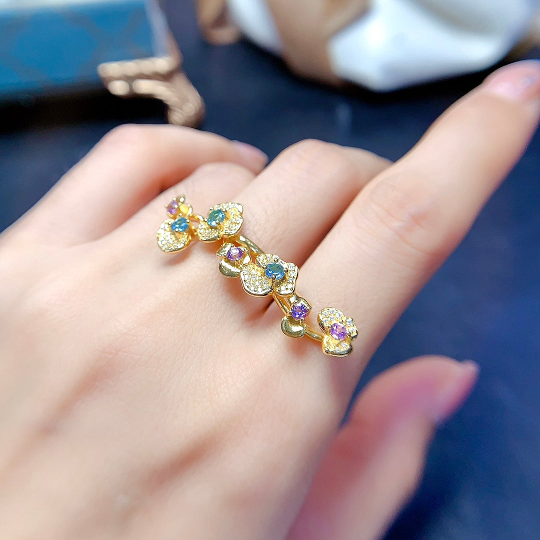 A ring crafted from natural crystal and topaz, this piece exudes a unique, floral-inspired design that resembles a delicate flower blooming on your hand.