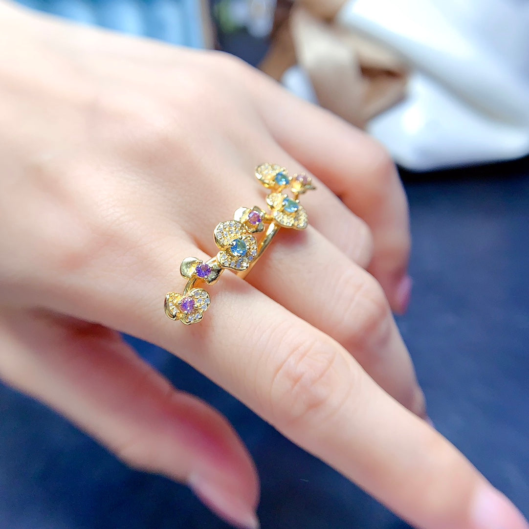 A ring crafted from natural crystal and topaz, this piece exudes a unique, floral-inspired design that resembles a delicate flower blooming on your hand.