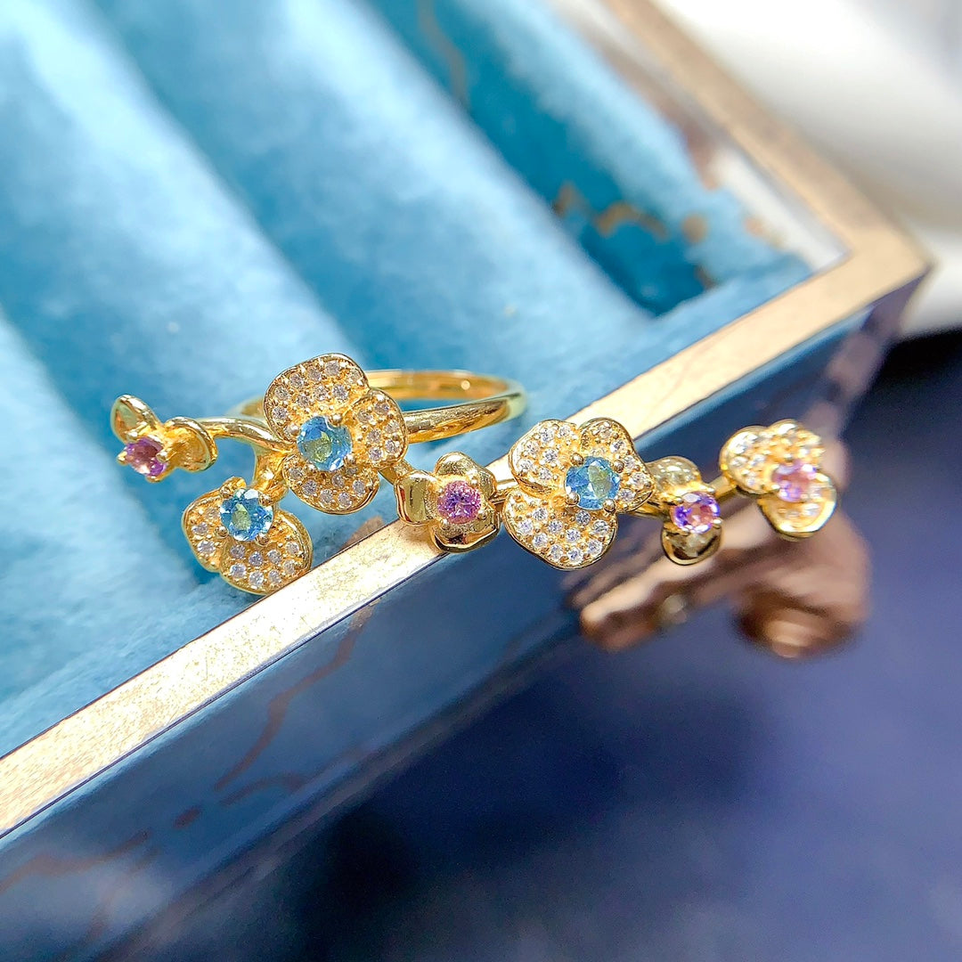 A ring crafted from natural crystal and topaz, this piece exudes a unique, floral-inspired design that resembles a delicate flower blooming on your hand.