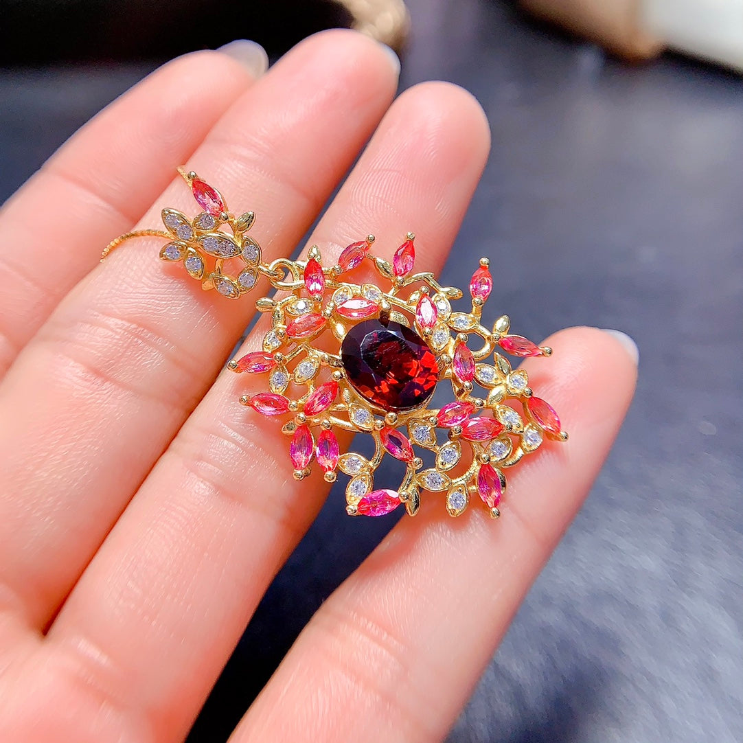 A uniquely designed pendant with two different colored gemstones: natural Topaz and Garnet. Choose the color you like the most!