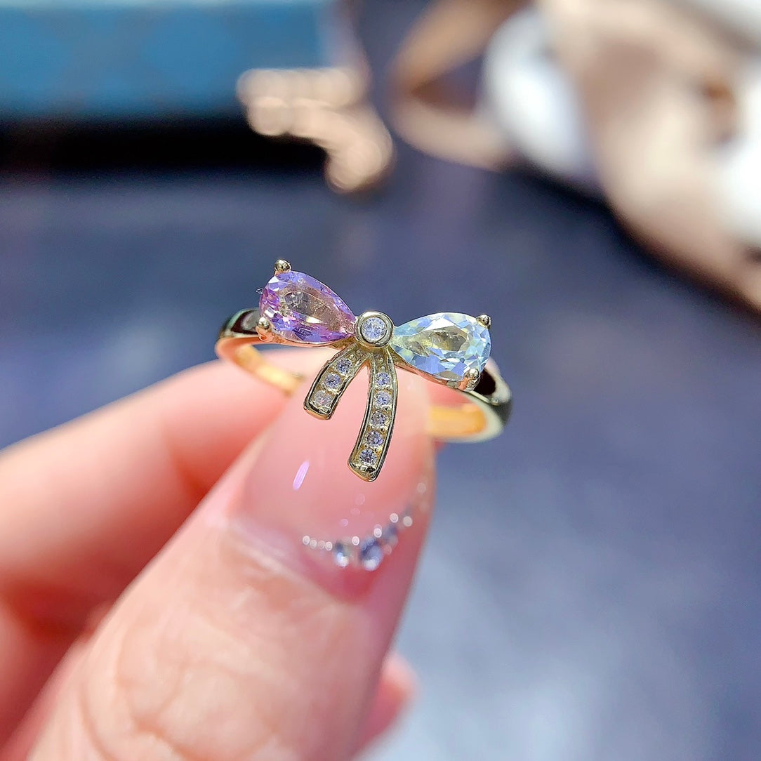 A set made of natural Topaz and crystal, featuring a cute bow design. The combination of two different colors makes it even more delicate.