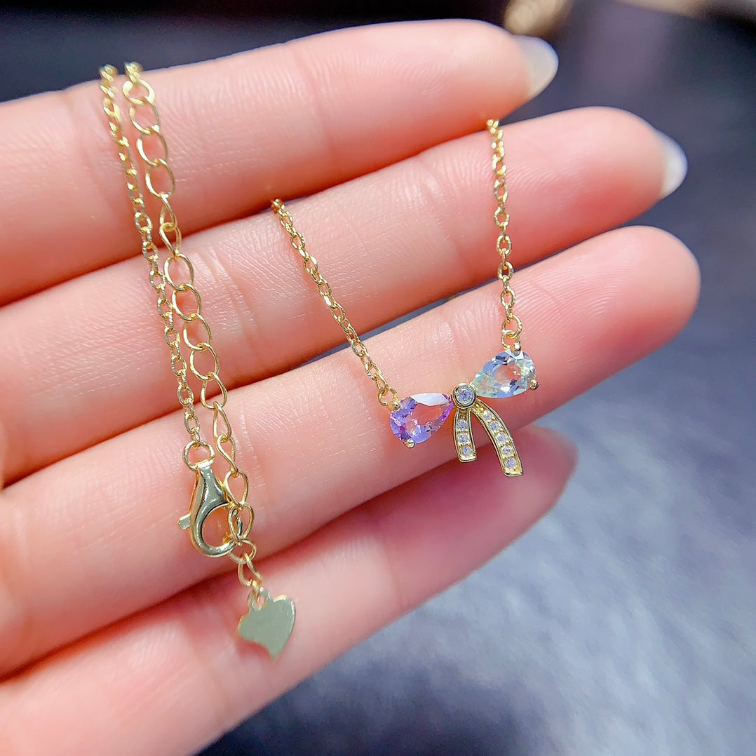 A set made of natural Topaz and crystal, featuring a cute bow design. The combination of two different colors makes it even more delicate.